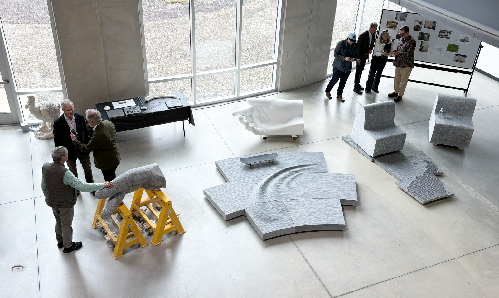 An overhead image of the Peace Corps Park design and fabrication teams with samples of all Park elements at Quarra Stone Co. in Madison, Wisconsin