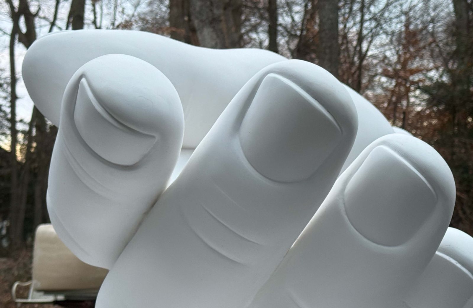A close-up image of the 2/3-scale plaster model of the hand form for Peace Corps Park's benches
